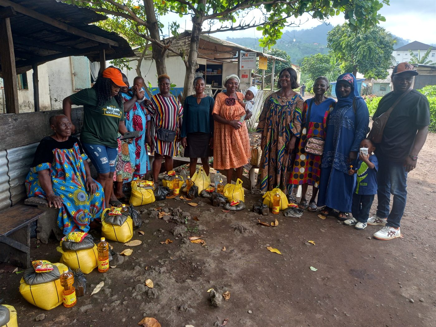 Community members and outreach team together after a distribution